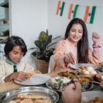 Mother and son enjoying a traditional Indian meal together at home, embracing cultural heritage.